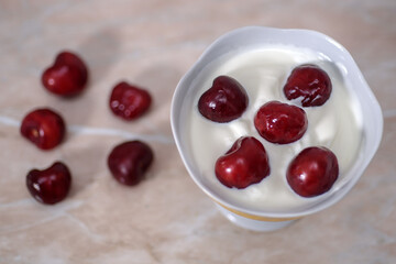 Cherries in cream on a light background