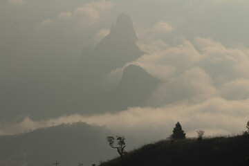 View of rangaswamy peek in kodanadu in the early morning. clouds passing or touching top of the peek or mountain in kodanadu