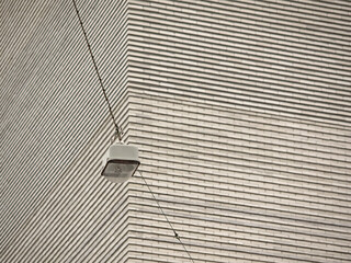 Street lamp optically free in front of exposed brickwork