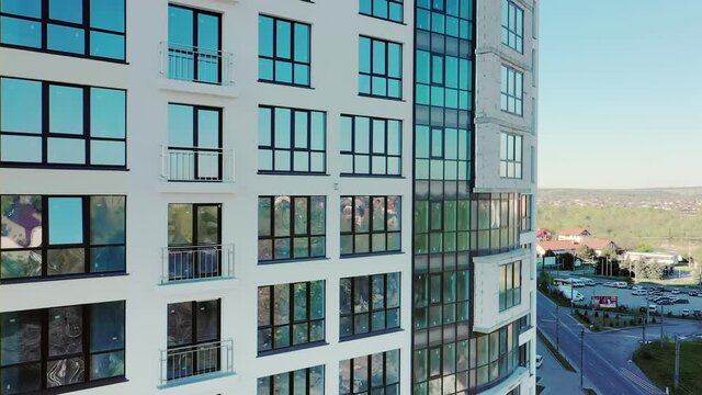 Many windows on new apartment building facade under construction. Real estate development