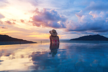Asian travel bikini woman relax in infinity pool at resort phuket beach Thailand - obrazy, fototapety, plakaty