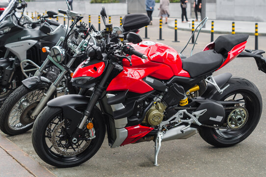 Ducati Streetfighter V4 S motorcycle parked in the city street. Red streetbike side view