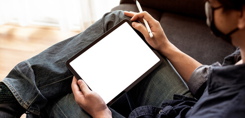 man using tablet blank screen in living room for working from home or using internet for online shopping and social network,online learning.