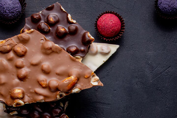 Chocolate bar, crushed pieces of dark chocolate and nuts. Praline Chocolate sweets
