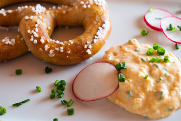 Obatzda, a Bavarian Cheese Spread also called Obatzter or Obazda with a Pretzel called Brezel or Laugenbrezel