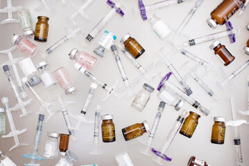 Lots of used syringes and vials with anti-aging cosmetic injections: mesotherapy, filler, botulinum...