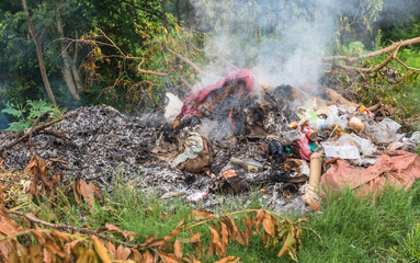 Piles of garbage being burned on the side of streets