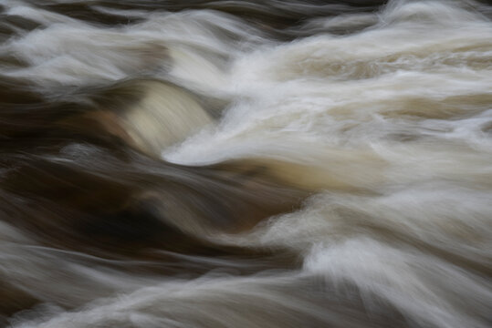 Stunning fine art collection of landscape images of long exposure detail of fast flowing water over rocks in river