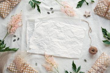 Summer minimal background with wild flowers and natural materials. Flat lay on off white textile...