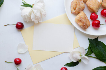 invitation card mockup and coffee, homemade cookies and cherry with peony flowers