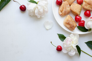 homemade cookies and cherry with peony flowers