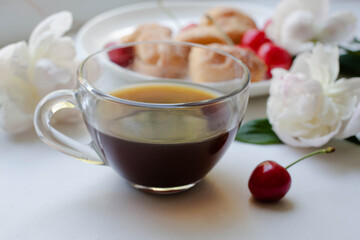 coffee, homemade cookies and cherry with peony flowers