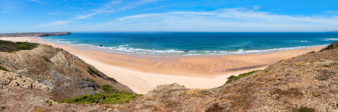 wide sandy beach Praia do Bordeira, blue atlantic ocean portugal