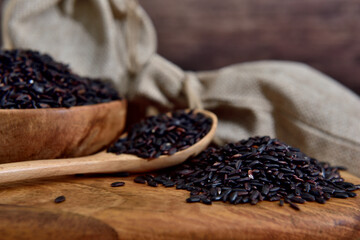 Organic black rice in a wooden bowl