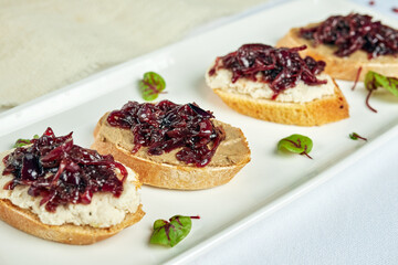 bruschetta with seaweed on a white plate on a light background