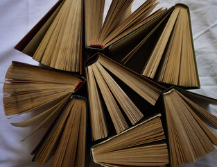 Naklejka premium old books stand open next to each other