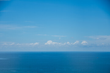 Naklejka na ściany i meble beautiful soft wave on sand at the sea with blue sky sunny day. subject is blurred.