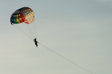 Parasailing over sea with beautiful blue sky background at Patong beach, Phuket,Thailand. soft socus.