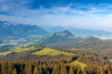 Obraz premium Panoramic landscape view of the Swiss Alpes,with blue sky in the background, shot in La Berra, Gruyère, Switzerland