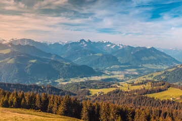 Naklejka na ściany i meble Panoramic landscape view of the Swiss Alpes,with blue sky in the background, shot in La Berra, Gruyère, Switzerland