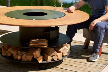 Kettle Grill Pit with Cast Iron Grid with flames . Round table-cooking surface. Hot BBQ on Backyard