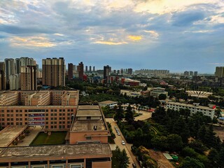 the clouds and buildings in the sunset