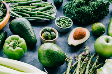 Healthy organic green food, assortment of fresh vegetables: Avocado, lettuce, broccoli, green peas, cucumber, pepper, celery, kale, asparagus and other.