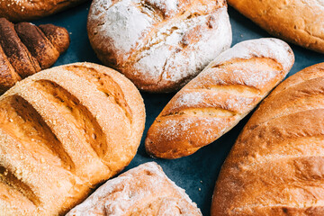 Different types of fresh bread and bakery on the table.