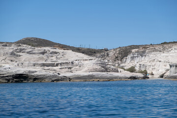 Sarakiniko beach at Milos island, Cyclades Greece. White rock formations, cliffs and caves over blue sea