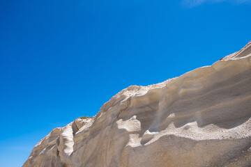 Lunar landscape at Sarakiniko beach, Milos island, Cyclades Greece, Abstract natural rock shapes. White stone formation, blue sky backgroynd.