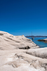 Sarakiniko beach at Milos island, Cyclades Greece. White rock formations, cliffs and caves over blue sea