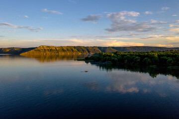 aerial view of fisherman at the boat on golden sunset river. silhouette of fishermen with his boat, Fisherman life style