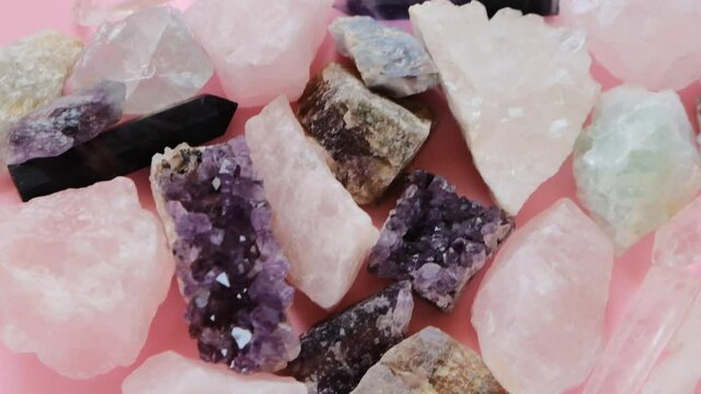Rose quartz, druse amethyst, rhinestone, fluorite crystal set close-up.precious stones and minerals on a pink background. Beautiful natural background