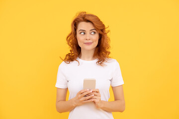 modern communication technology. dreamy redhead woman working online.