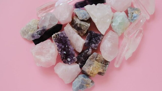 Rose quartz, druse amethyst, rhinestone, fluorite crystal set close-up.precious stones and minerals on a pink background. Beautiful natural background.Amulets and talismans