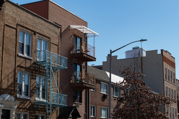 Fototapeta na wymiar Row of Brick Residential Buildings along a Street in Astoria Queens New York
