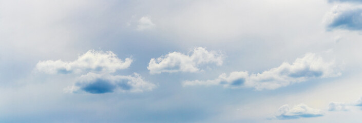 Small fluffy clouds in the sky in cloudy weather, panorama