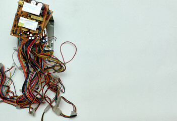 Disassembled power supply of a stationary personal computer on an isolated background. Electronics...