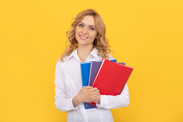 Fototapeta premium happy blonde businesswoman woman in white shirt hold notepad or notebook, teacher