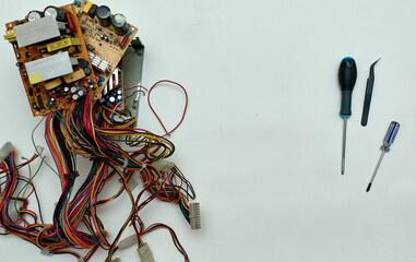 Disassembled power supply of a stationary personal computer on an isolated background. Repair of computer equipment.
