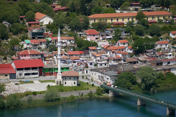 Fototapeta premium Aerial view of city Shkoder, mosque at river near big lake and castel hill