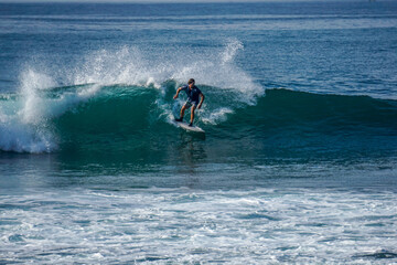 Surfer on perfect blue aquamarine wave, empty line up, perfect for surfing, clean water, Indian Ocean close to Mirissa