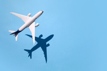Model plane, airplane on sky blue background with deep shadow