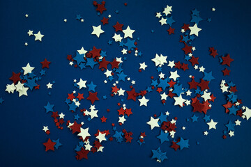4th of July American Independence Day stars decorations on blue background. Flat lay, top view.