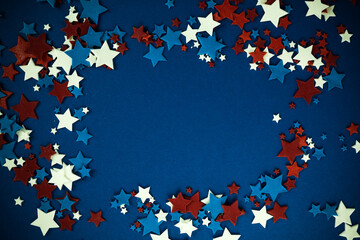 4th of July American Independence Day stars decorations frame on blue background. Flat lay, top view.