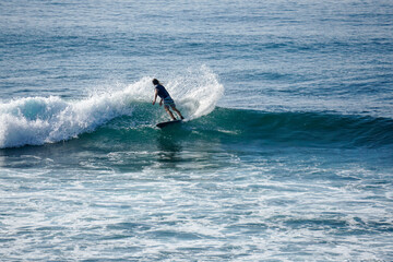 Surfer on perfect blue aquamarine wave, empty line up, perfect for surfing, clean water, Indian Ocean close to Mirissa