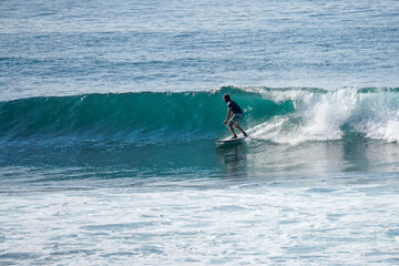 Surfer on perfect blue aquamarine wave, empty line up, perfect for surfing, clean water, Indian Ocean close to Mirissa