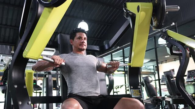 Caucasian Man Playing Vertical Bench Press Machine to Build Chest Muscle