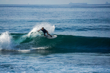 Surfer on perfect blue aquamarine wave, empty line up, perfect for surfing, clean water, Indian...