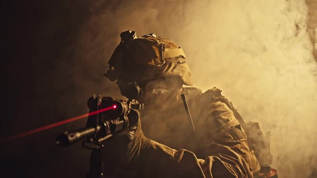 US marine soldier aiming with rifle at night in darkness